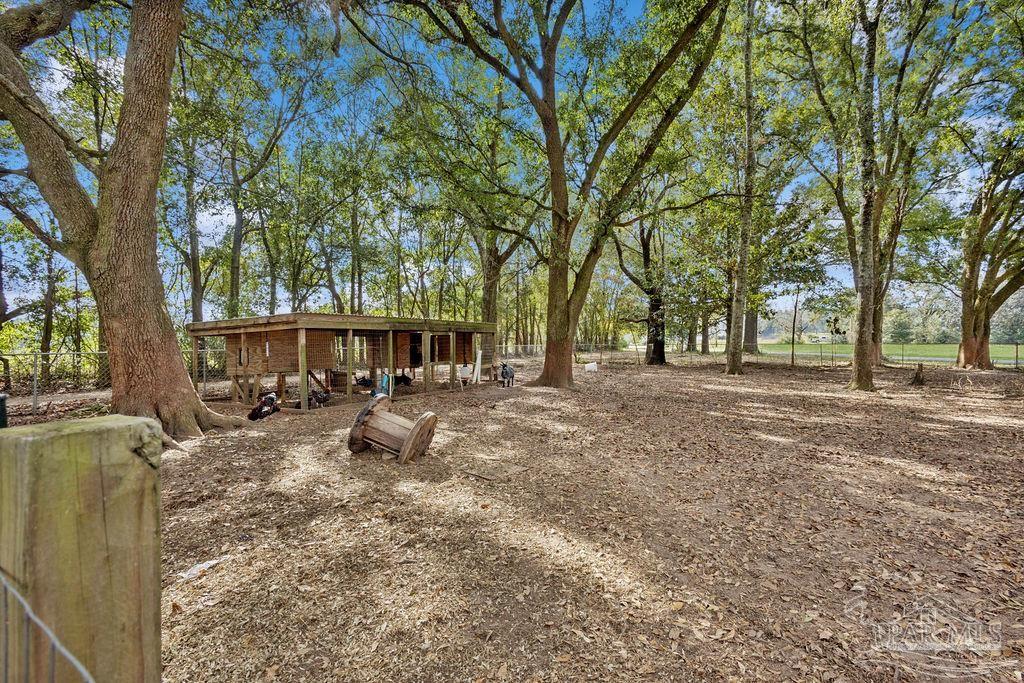 8240 Tidwell Road Pace, FL 32571 - Photo 38 of 41 a view of a house with backyard and sitting area