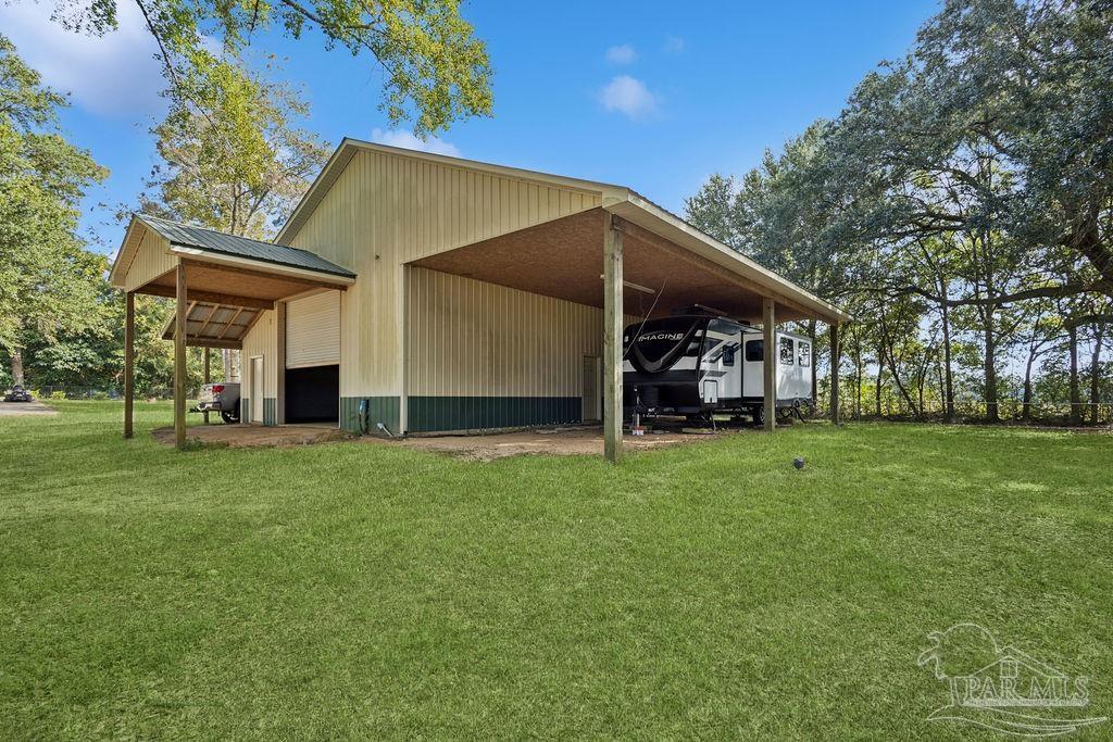 8240 Tidwell Road Pace, FL 32571 - Photo 6 of 41 a view of a back yard of the house