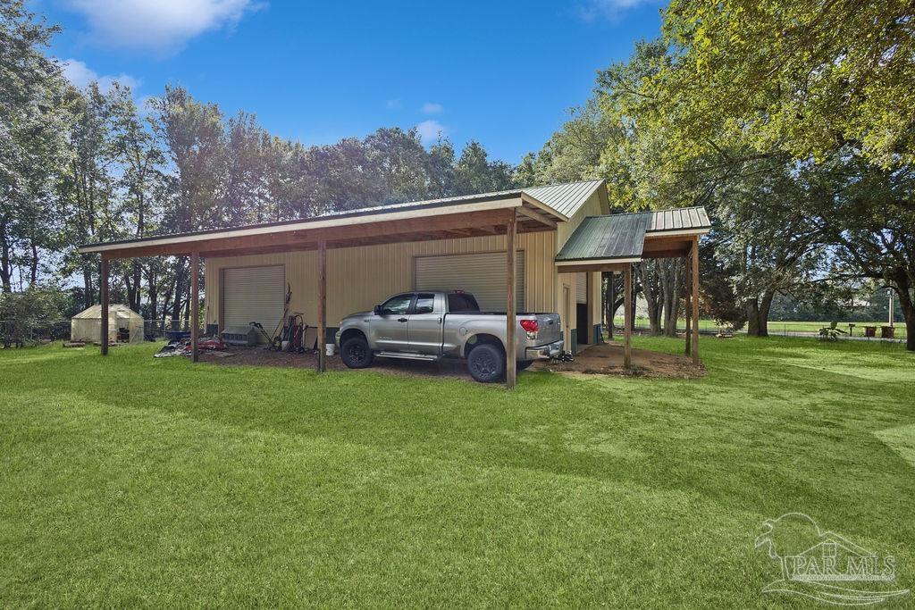 8240 Tidwell Road Pace, FL 32571 - Photo 8 of 41 a view of a house with a back yard