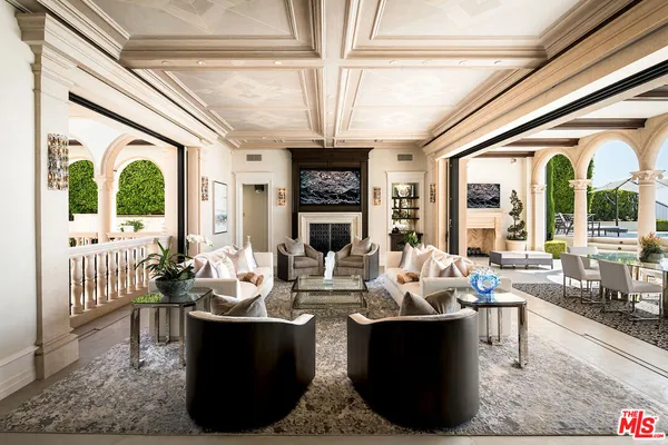 a living room with fireplace furniture and a large window