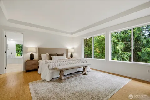 a spacious bedroom with a bed and a large window
