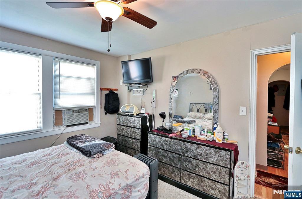 949 Front Plainfield, NJ 07062 - Photo 11 of 15 a bedroom with furniture a flat screen tv and a window