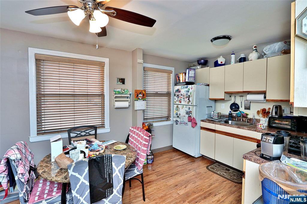 949 Front Plainfield, NJ 07062 - Photo 4 of 15 a kitchen with stainless steel appliances granite countertop wooden floor cabinets dining table and chairs