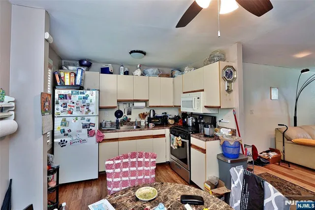 a kitchen with a refrigerator and a stove