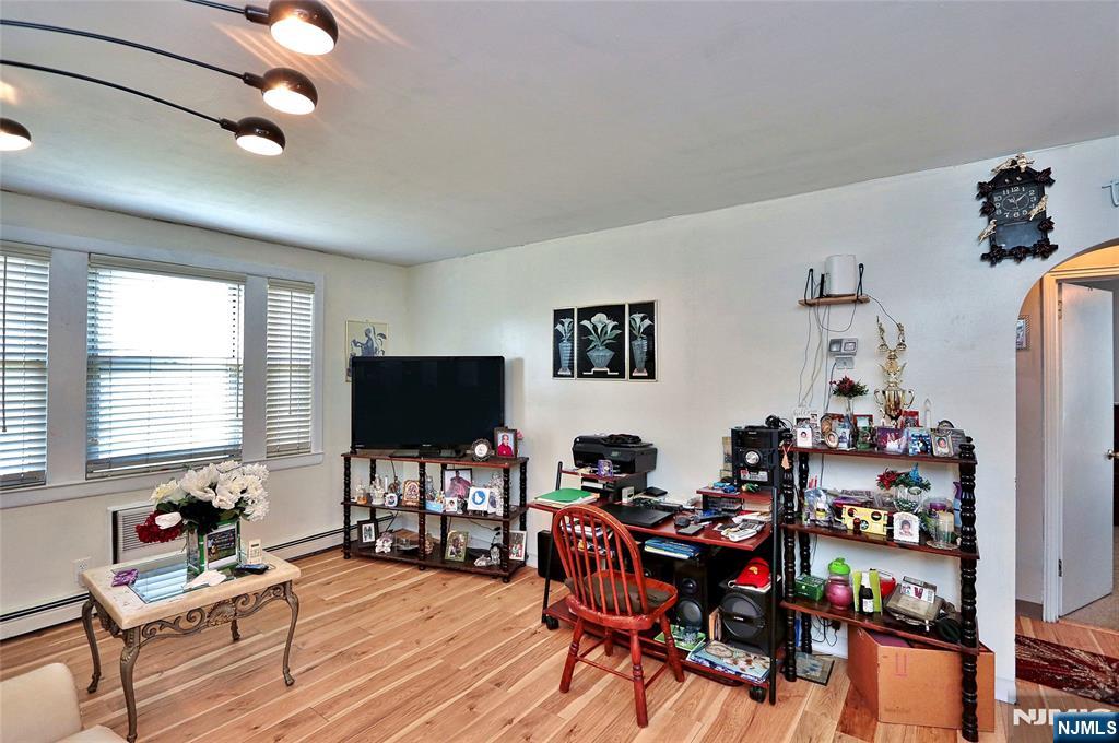 949 Front Plainfield, NJ 07062 - Photo 8 of 15 a living room with furniture a flat screen tv and a window