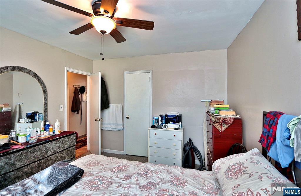 949 Front Plainfield, NJ 07062 - Photo 10 of 15 a bedroom with a bed and a chandelier