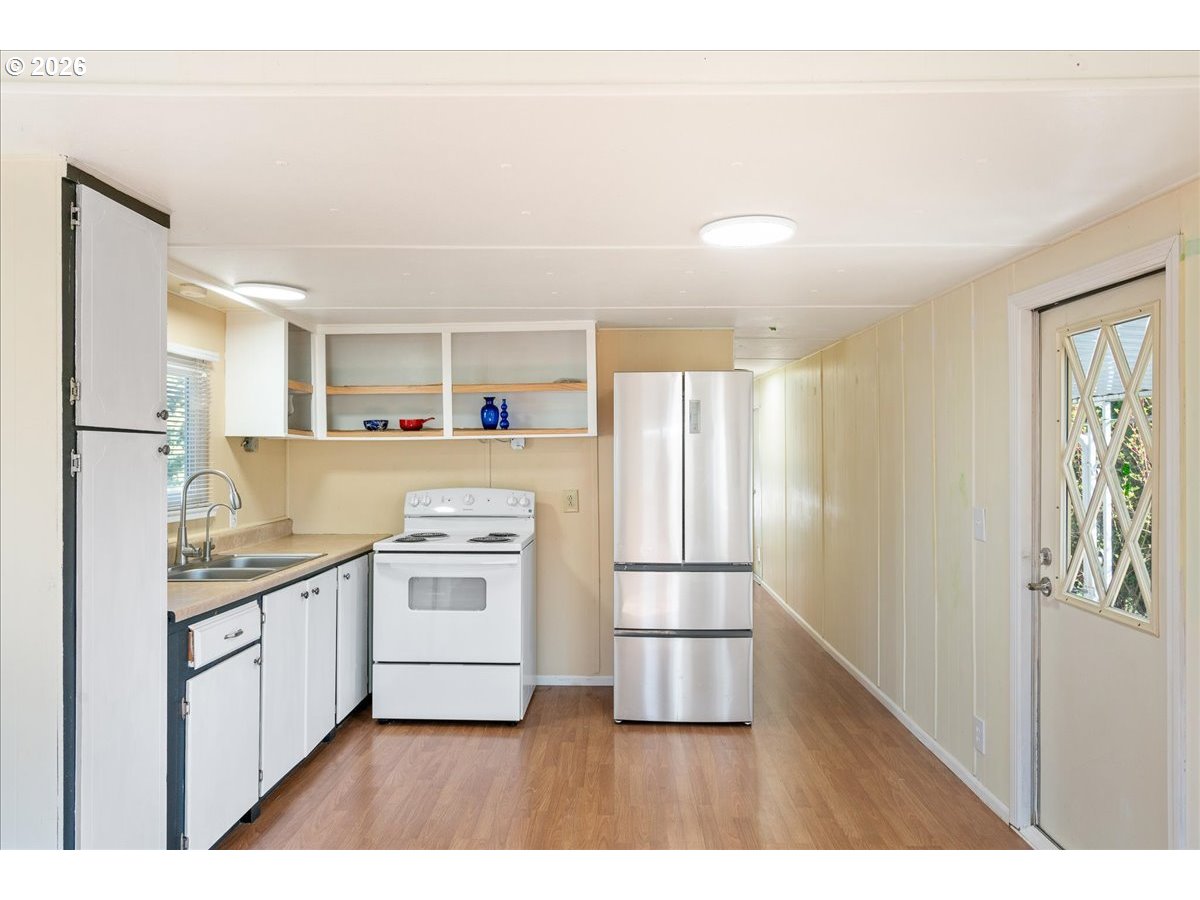 1418 Pine Street, Unit 7 Silverton, OR 97381 - Photo 12 of 27 a kitchen with stainless steel appliances granite countertop a refrigerator and a stove top oven