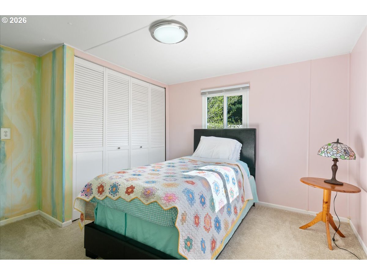 1418 Pine Street, Unit 7 Silverton, OR 97381 - Photo 13 of 27 a bedroom with a bed and a chandelier