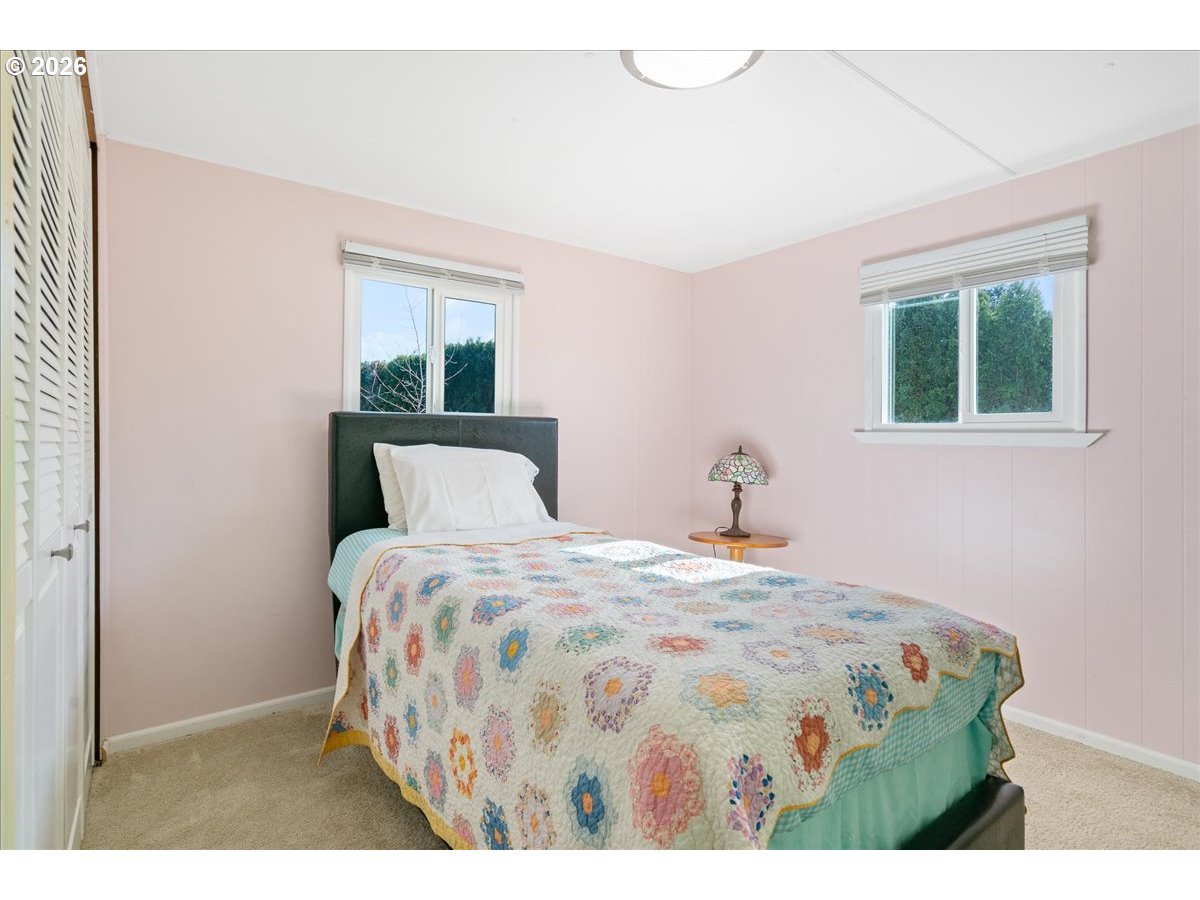 1418 Pine Street, Unit 7 Silverton, OR 97381 - Photo 14 of 27 a bedroom with a bed and a window