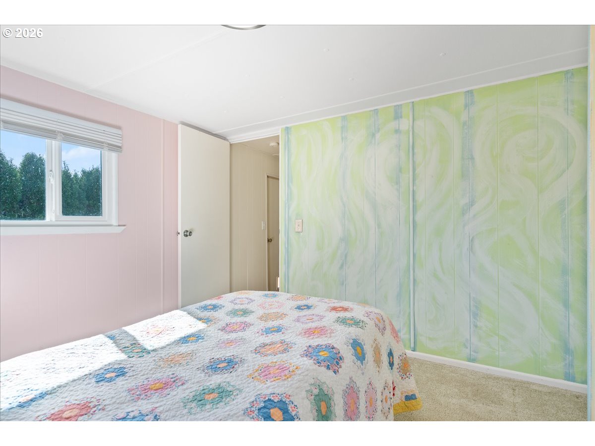 1418 Pine Street, Unit 7 Silverton, OR 97381 - Photo 15 of 27 a bedroom with a bed and a window