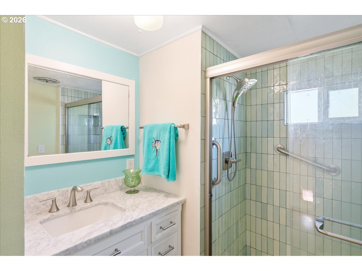 1418 Pine Street, Unit 7 Silverton, OR 97381 - Photo 17 of 27 a bathroom with a granite countertop sink and a mirror