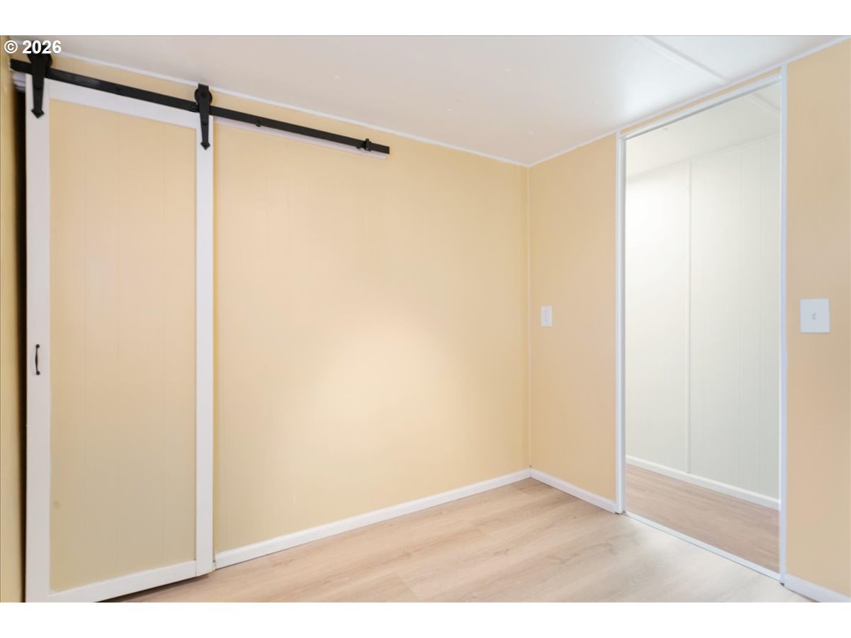 1418 Pine Street, Unit 7 Silverton, OR 97381 - Photo 20 of 27 a view of a room with wooden floor and a window