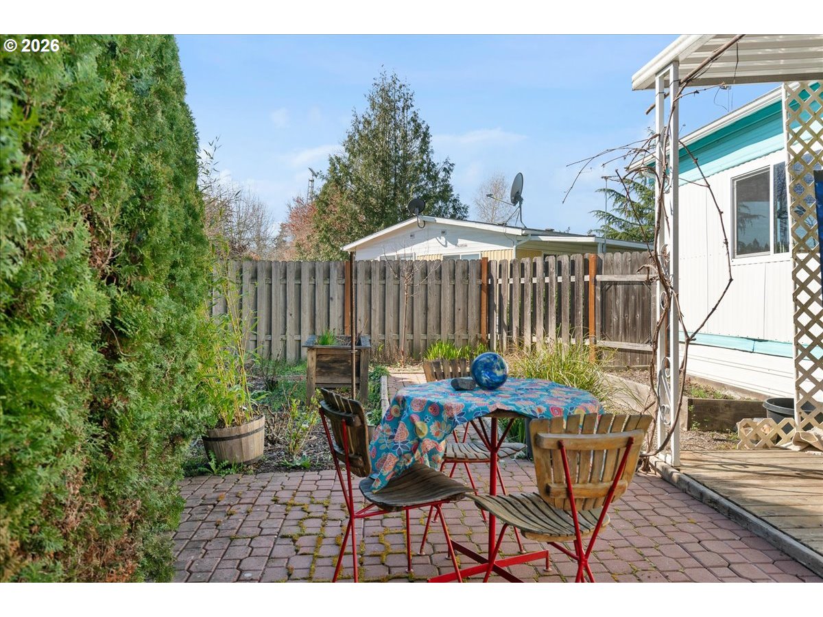 1418 Pine Street, Unit 7 Silverton, OR 97381 - Photo 22 of 27 a view of a table and chairs in patio of the house