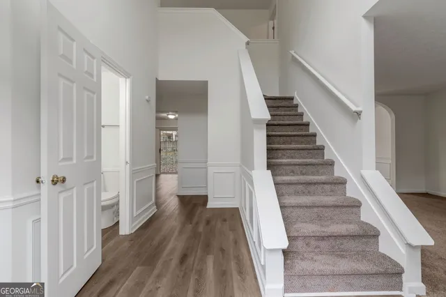 a view of a hallway with wooden floor and entryway