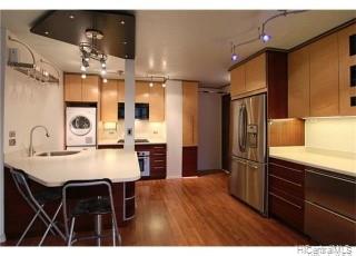 a kitchen with kitchen island a sink stove and refrigerator