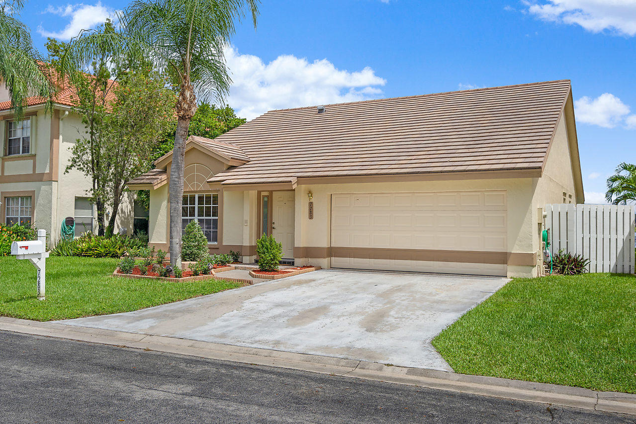 7283 Shell Ridge Terrace Lake Worth, FL 33467 - Photo 32 of 32 a front view of house with yard and green space