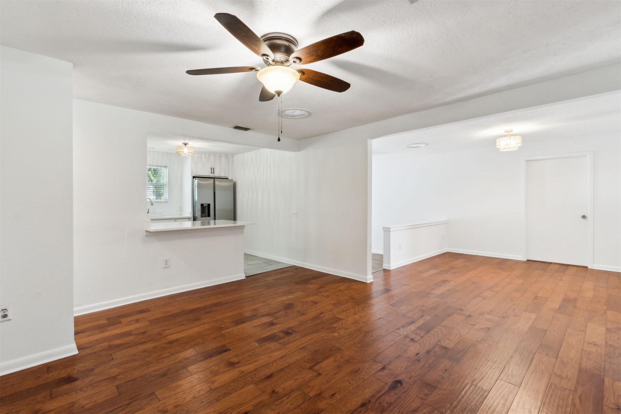 2441 Amelia Road Fernandina Beach, FL 32034 - Photo 10 of 36 an empty room with wooden floor and windows