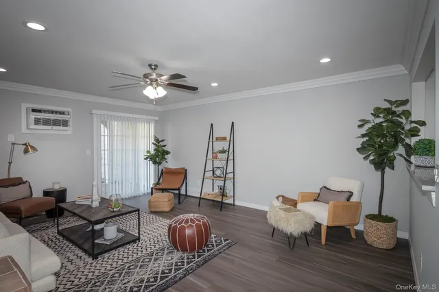 a living room with furniture potted plant and wooden floor
