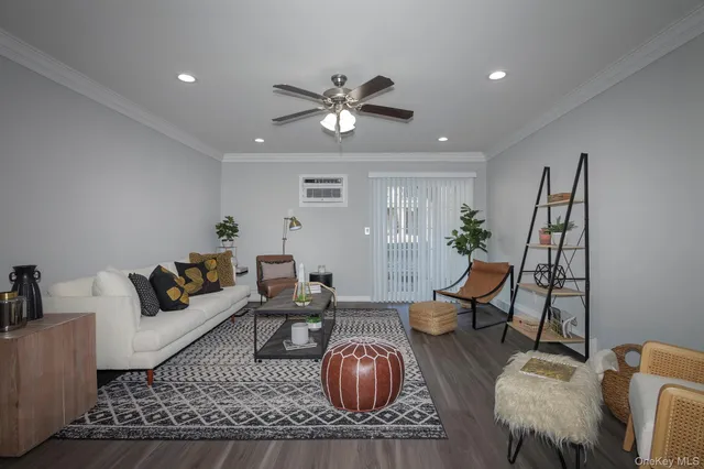 a living room with furniture a chandelier and a rug