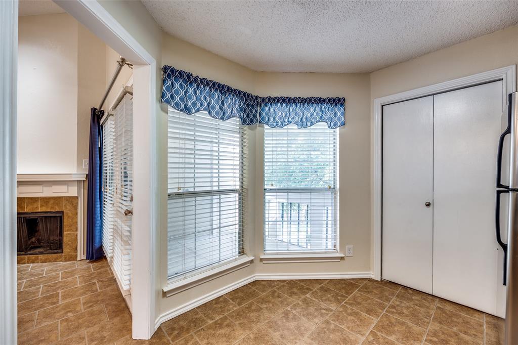 14277 Preston Road, Unit 423 Dallas, TX 75254 - Photo 13 of 31 a view of an empty room with a fireplace and a window