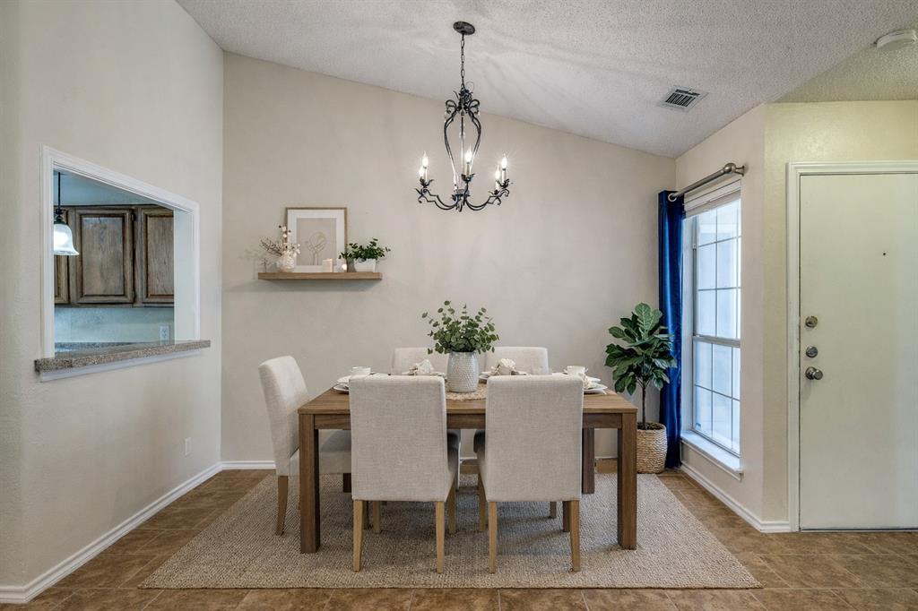 14277 Preston Road, Unit 423 Dallas, TX 75254 - Photo 2 of 31 a view of a dining room with furniture and chandelier