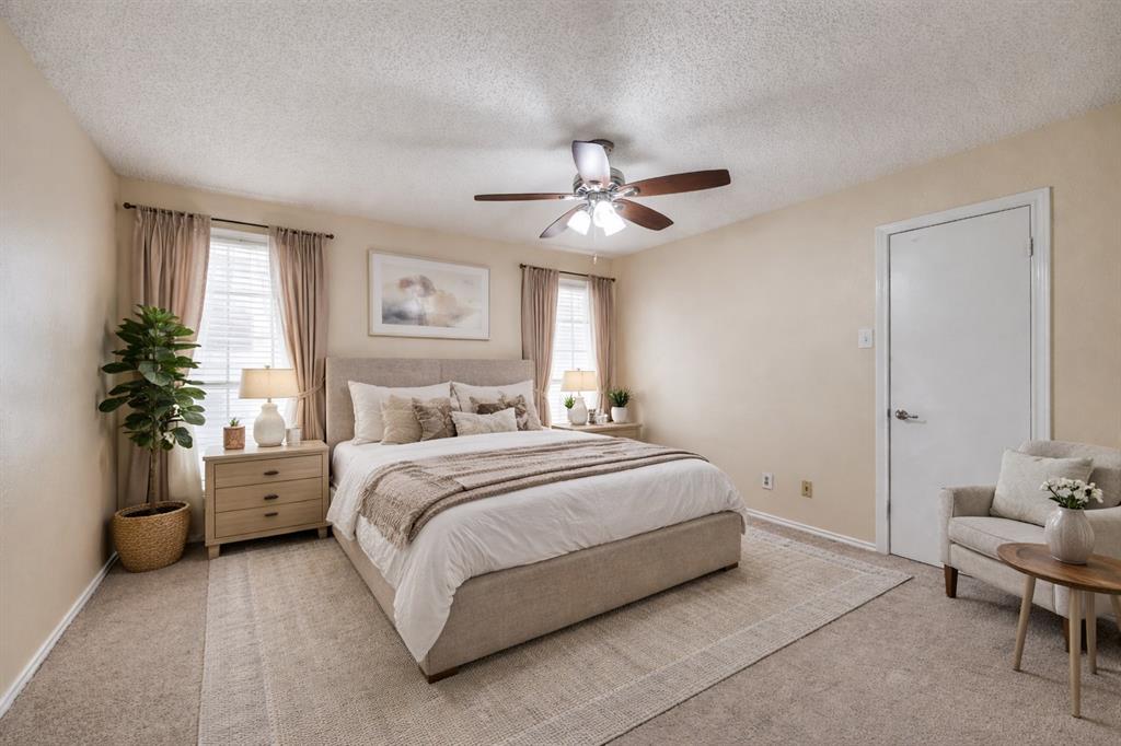 14277 Preston Road, Unit 423 Dallas, TX 75254 - Photo 3 of 31 a spacious bedroom with a bed and a chandelier