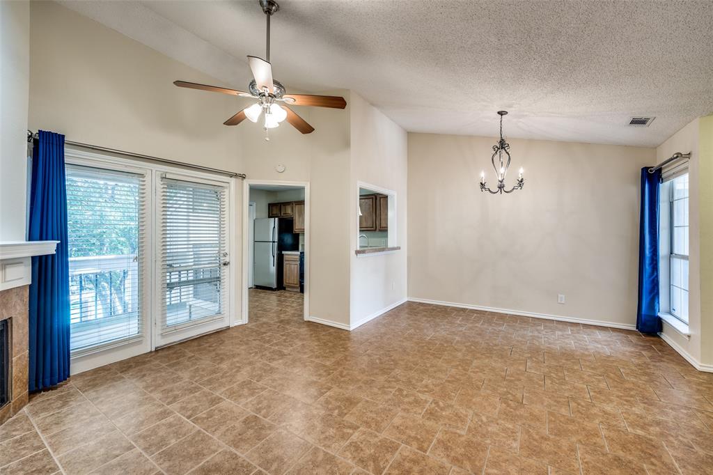 14277 Preston Road, Unit 423 Dallas, TX 75254 - Photo 8 of 31 a view of a livingroom with a chandelier fan and windows