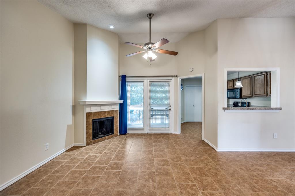 14277 Preston Road, Unit 423 Dallas, TX 75254 - Photo 10 of 31 a view of empty room with a fireplace and fan