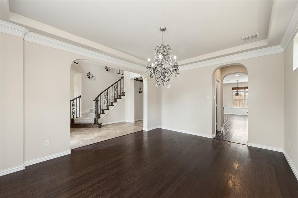 12571 Valley Spring Drive Frisco, TX 75035 - Photo 6 of 39 a view of a room with wooden floor chandelier and entryway