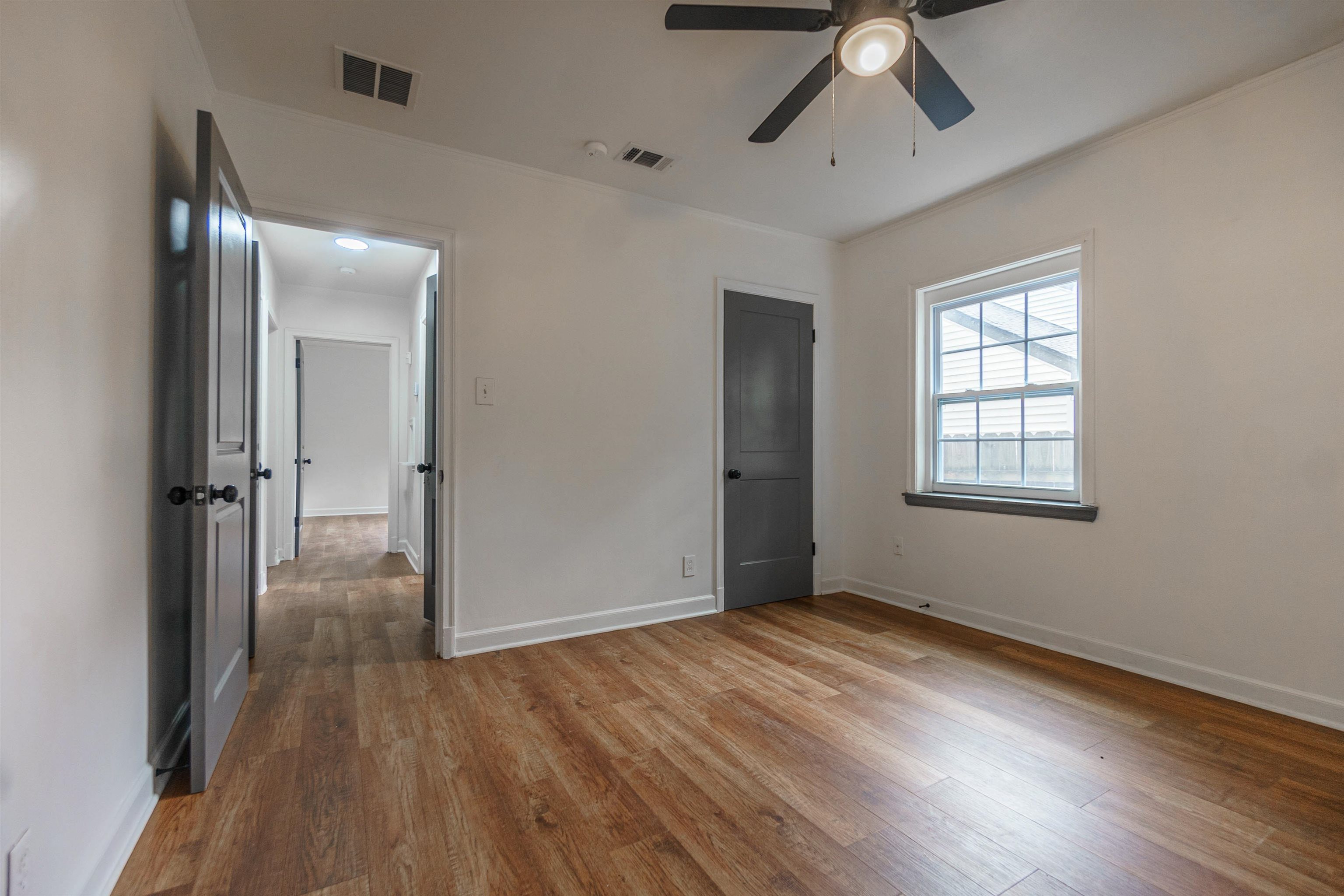 1069 Railton Road Memphis, TN 38111 - Photo 11 of 17 wooden floor in an empty room with a window