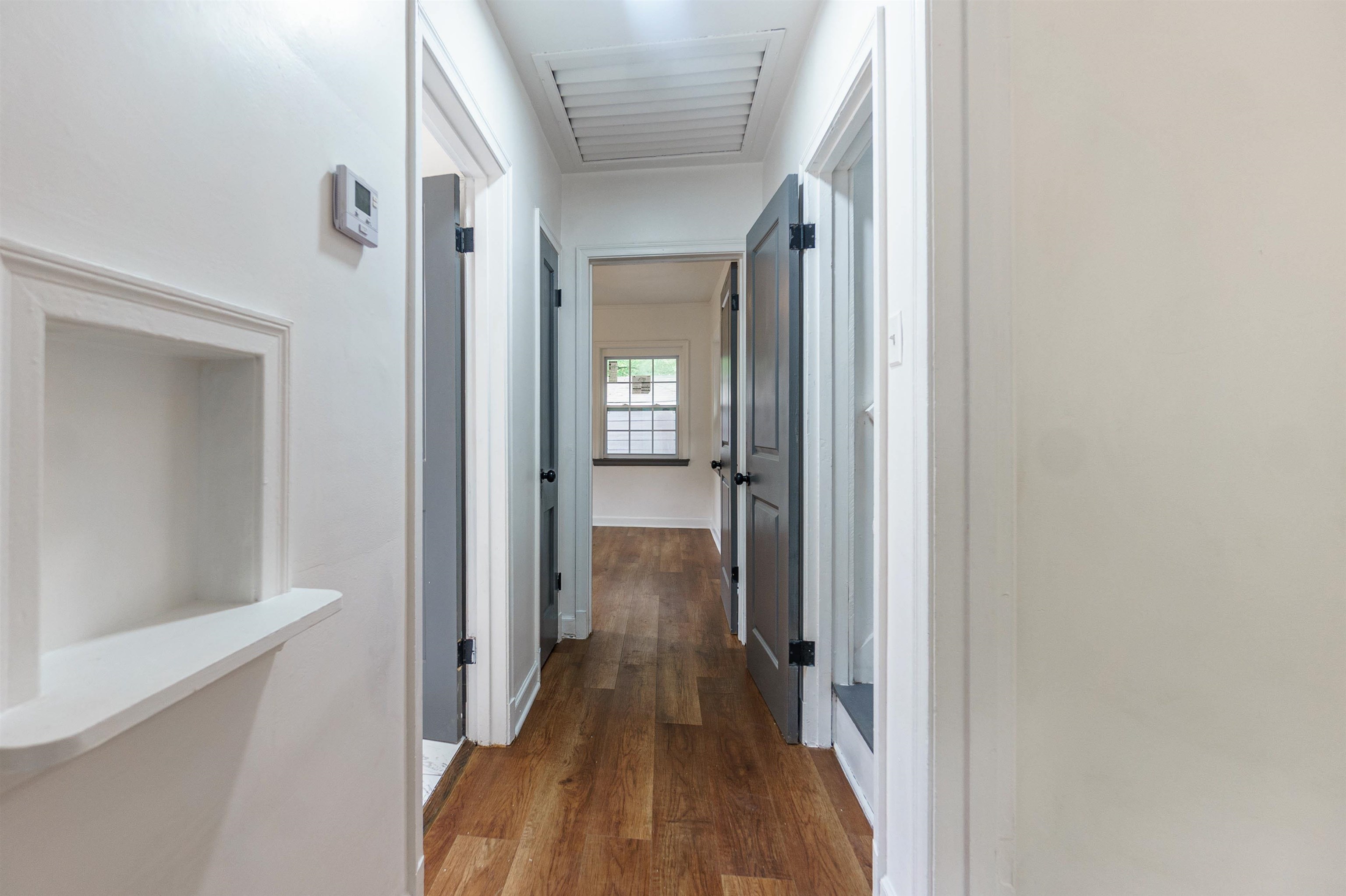 1069 Railton Road Memphis, TN 38111 - Photo 13 of 17 a view of a hallway with wooden floor and a bathroom