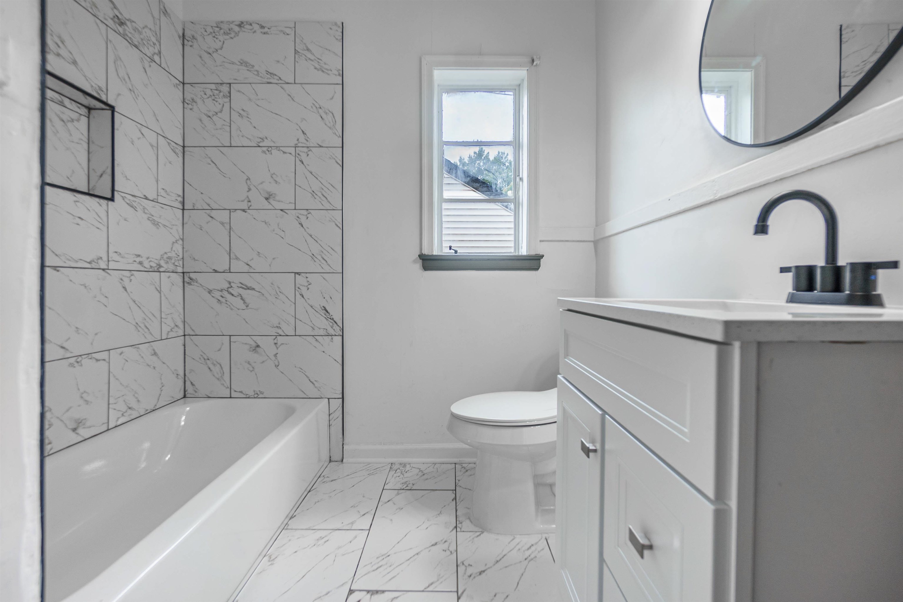 1069 Railton Road Memphis, TN 38111 - Photo 14 of 17 a bathroom with a sink a toilet and bathtub