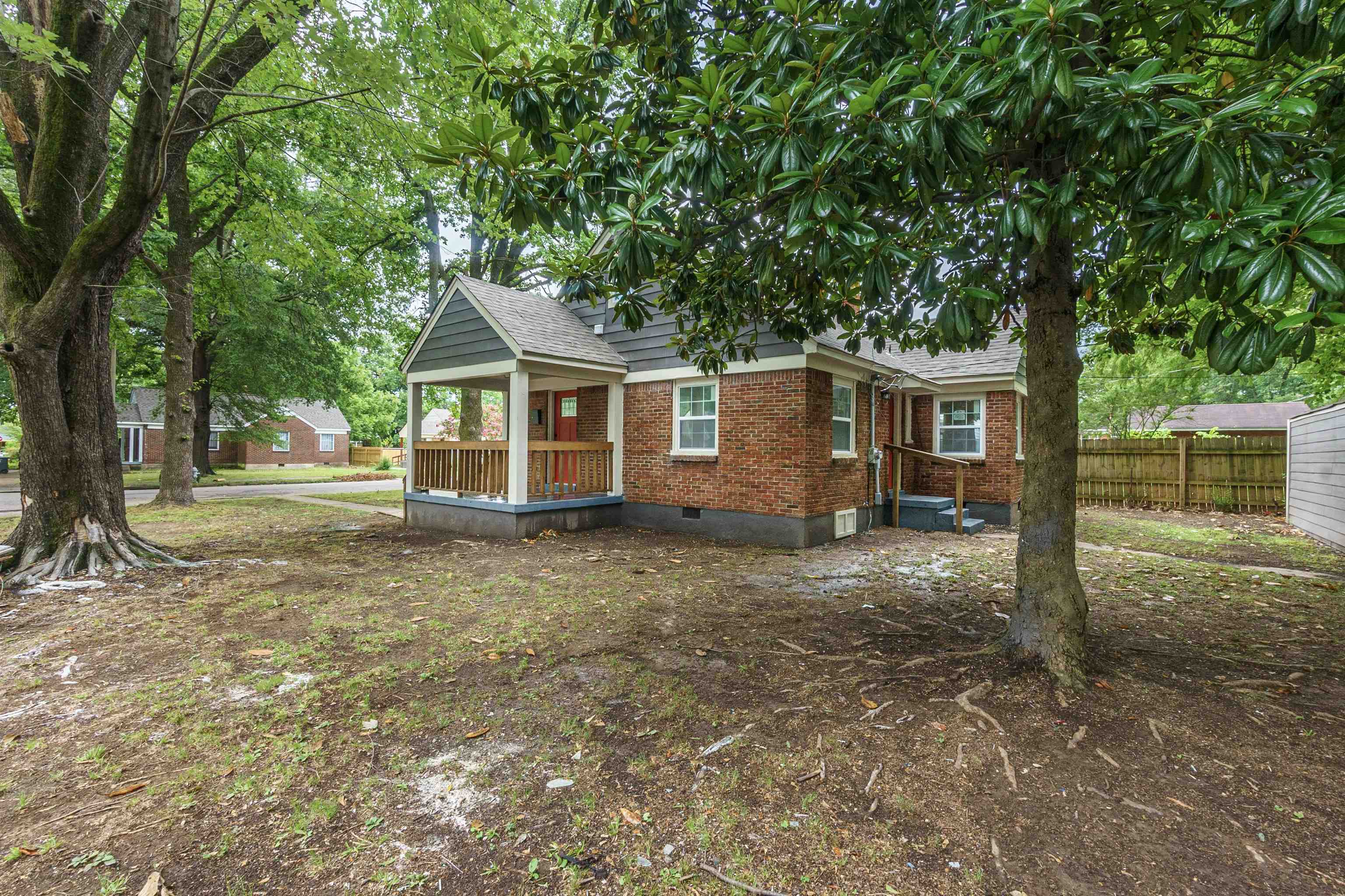 1069 Railton Road Memphis, TN 38111 - Photo 2 of 17 a view of a house with a yard tree and a large tree
