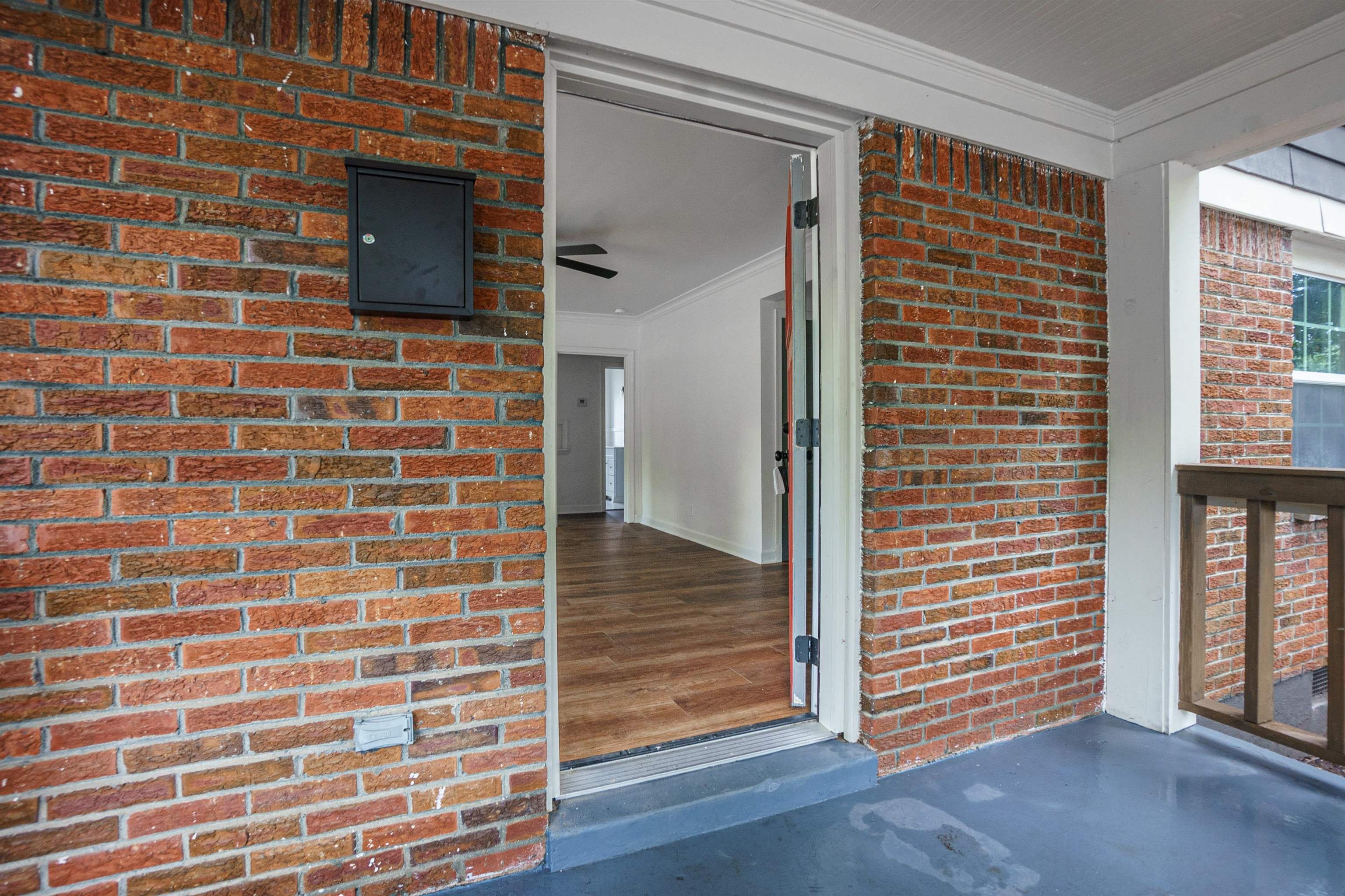 1069 Railton Road Memphis, TN 38111 - Photo 4 of 17 a view of an empty room with wooden floor and a window