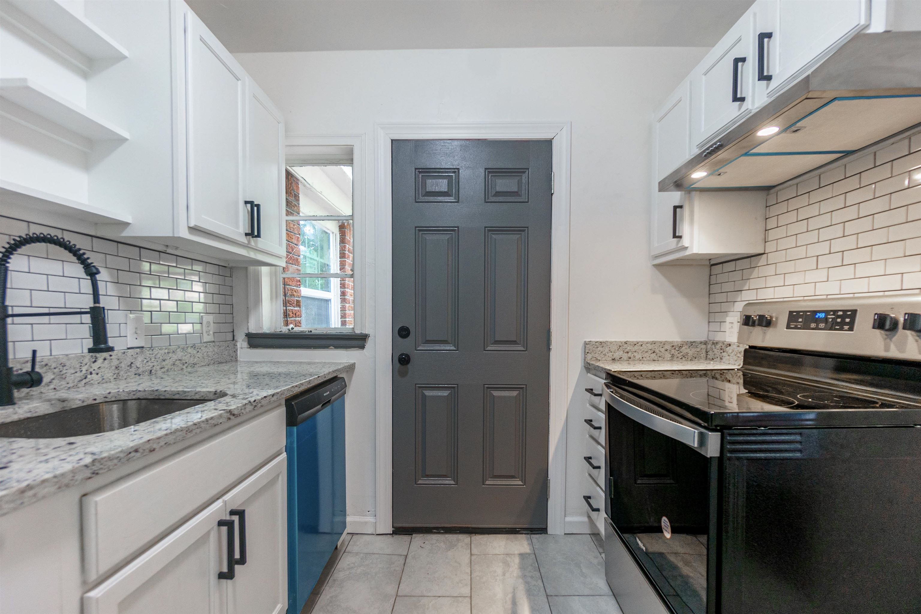 1069 Railton Road Memphis, TN 38111 - Photo 6 of 17 a kitchen with stainless steel appliances granite countertop a sink stove and cabinets