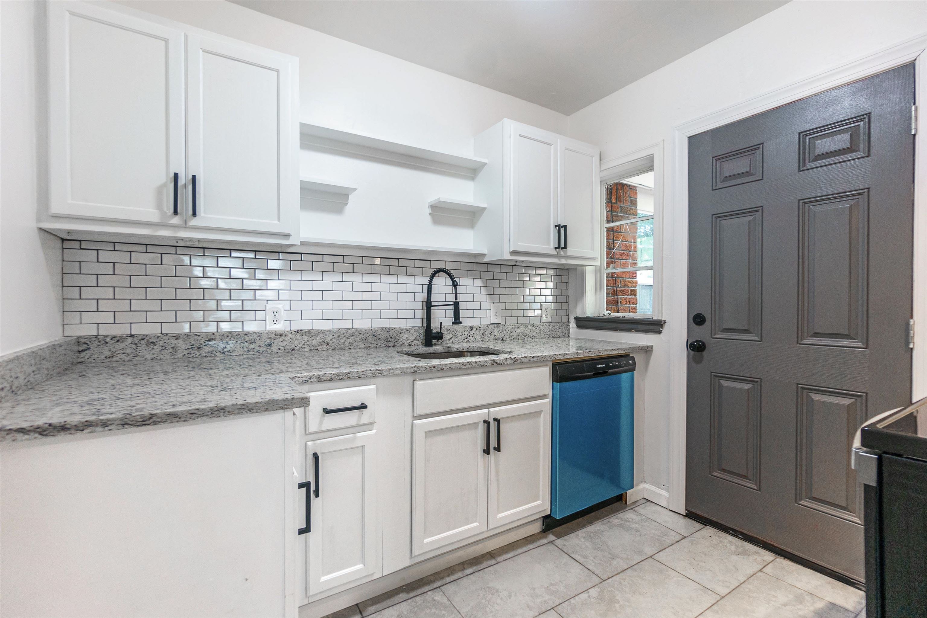1069 Railton Road Memphis, TN 38111 - Photo 7 of 17 a kitchen with granite countertop a sink stainless steel appliances and cabinets