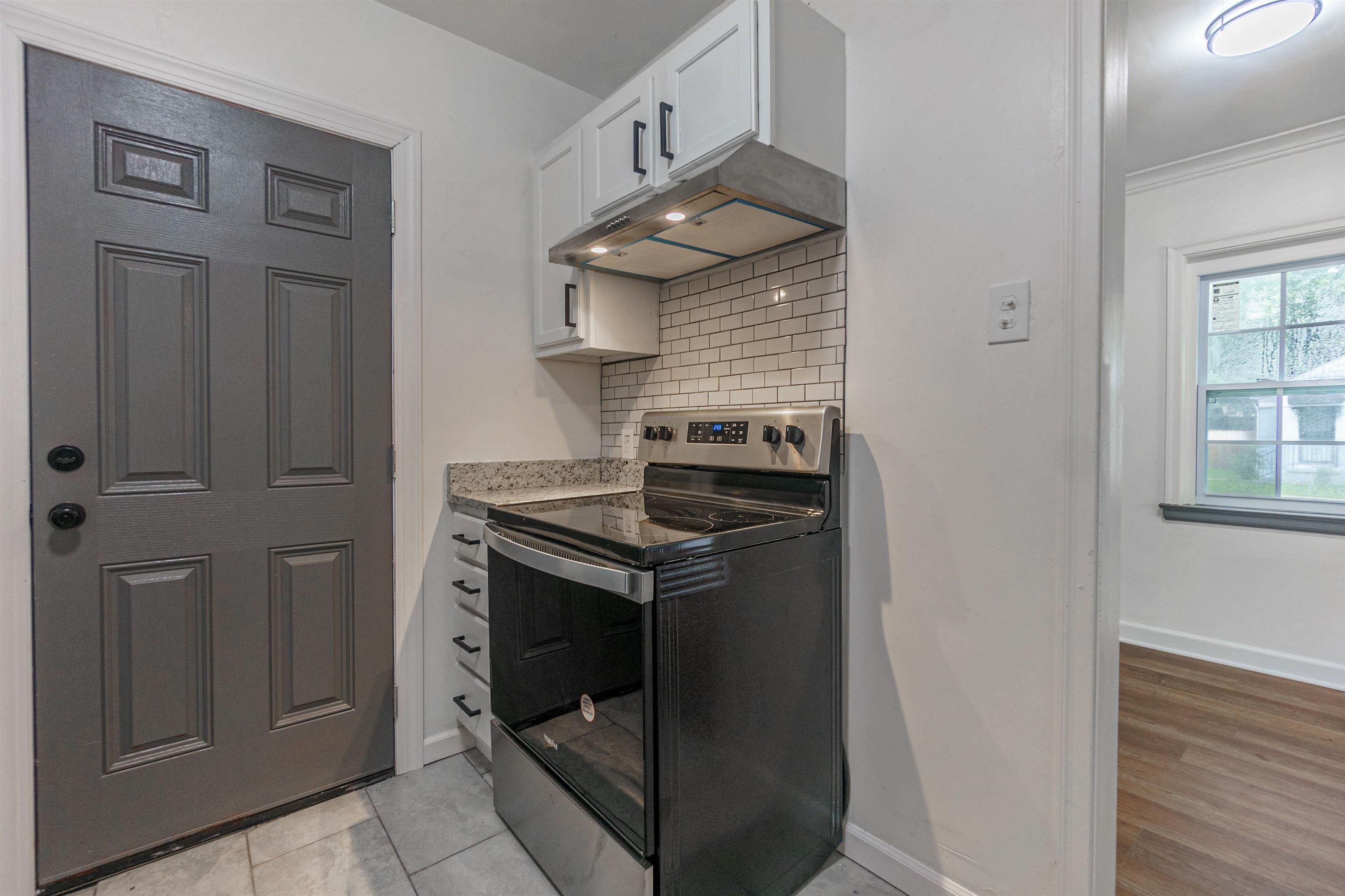 1069 Railton Road Memphis, TN 38111 - Photo 8 of 17 a kitchen with stainless steel appliances granite countertop a stove and a refrigerator