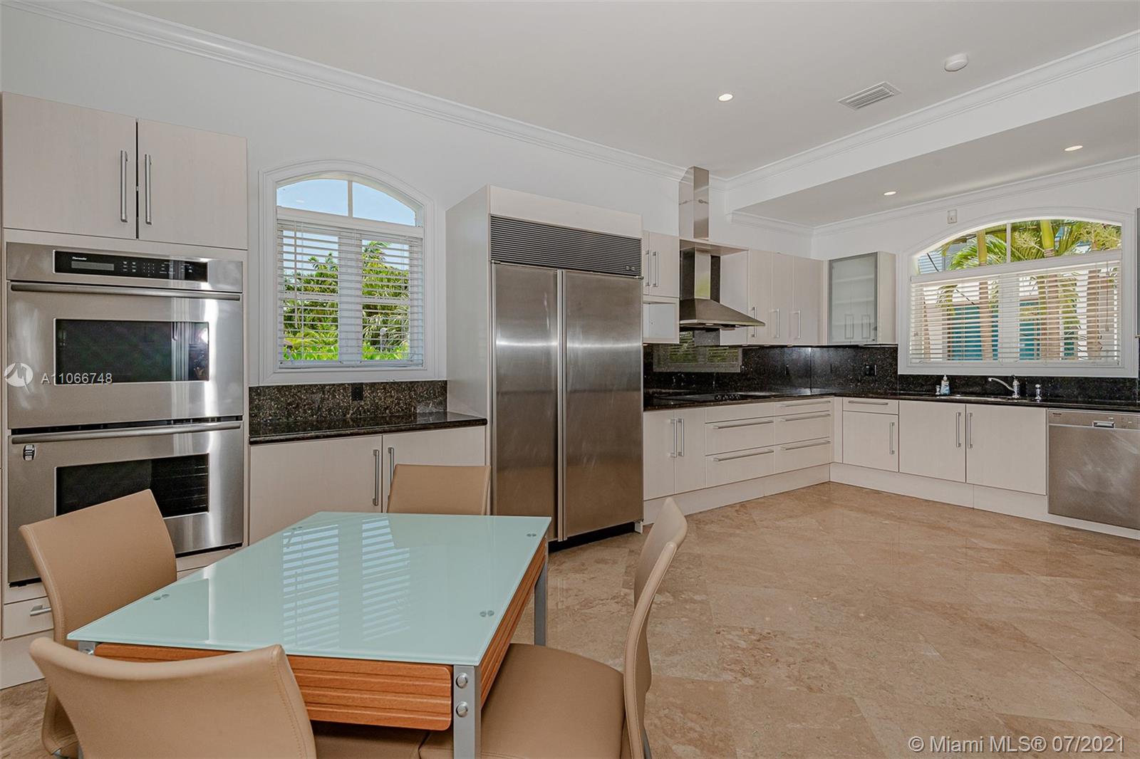 442 Woodcrest Road Key Biscayne, FL 33149 - Photo 12 of 48 a kitchen with granite countertop a stove a sink and a refrigerator
