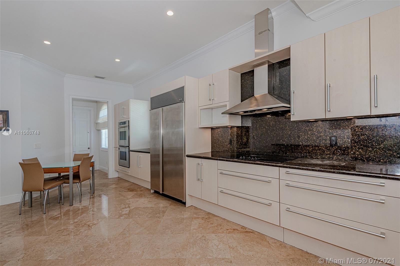 442 Woodcrest Road Key Biscayne, FL 33149 - Photo 14 of 48 a kitchen with stainless steel appliances granite countertop a sink and a refrigerator