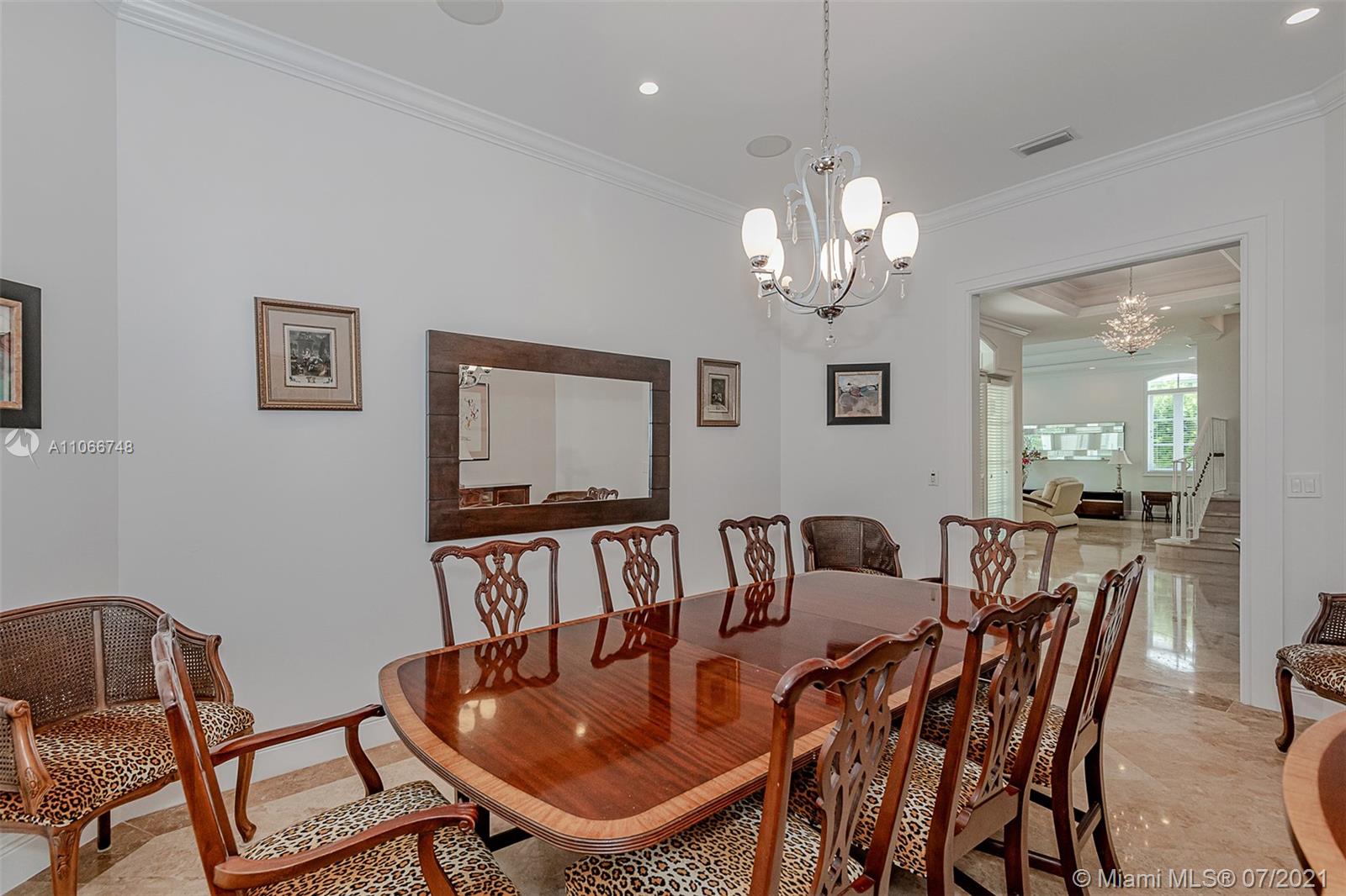 442 Woodcrest Road Key Biscayne, FL 33149 - Photo 16 of 48 a view of a dining room with furniture a chandelier and wooden floor