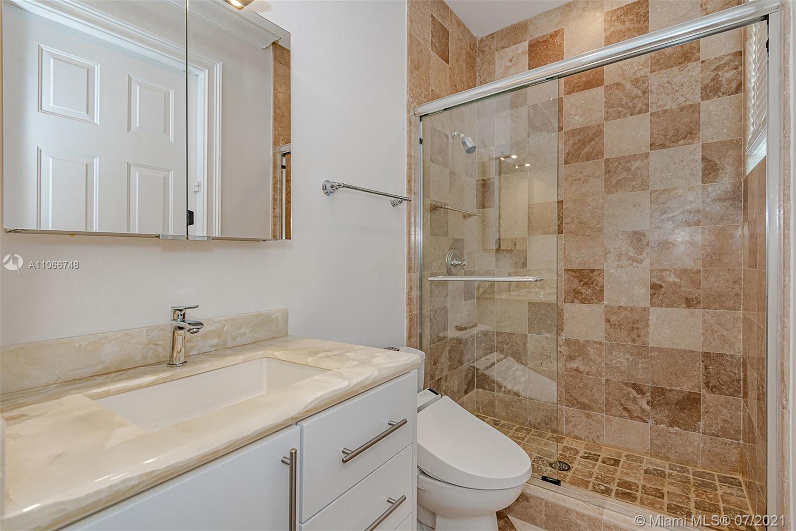 442 Woodcrest Road Key Biscayne, FL 33149 - Photo 25 of 48 a bathroom with a granite countertop sink a toilet and shower