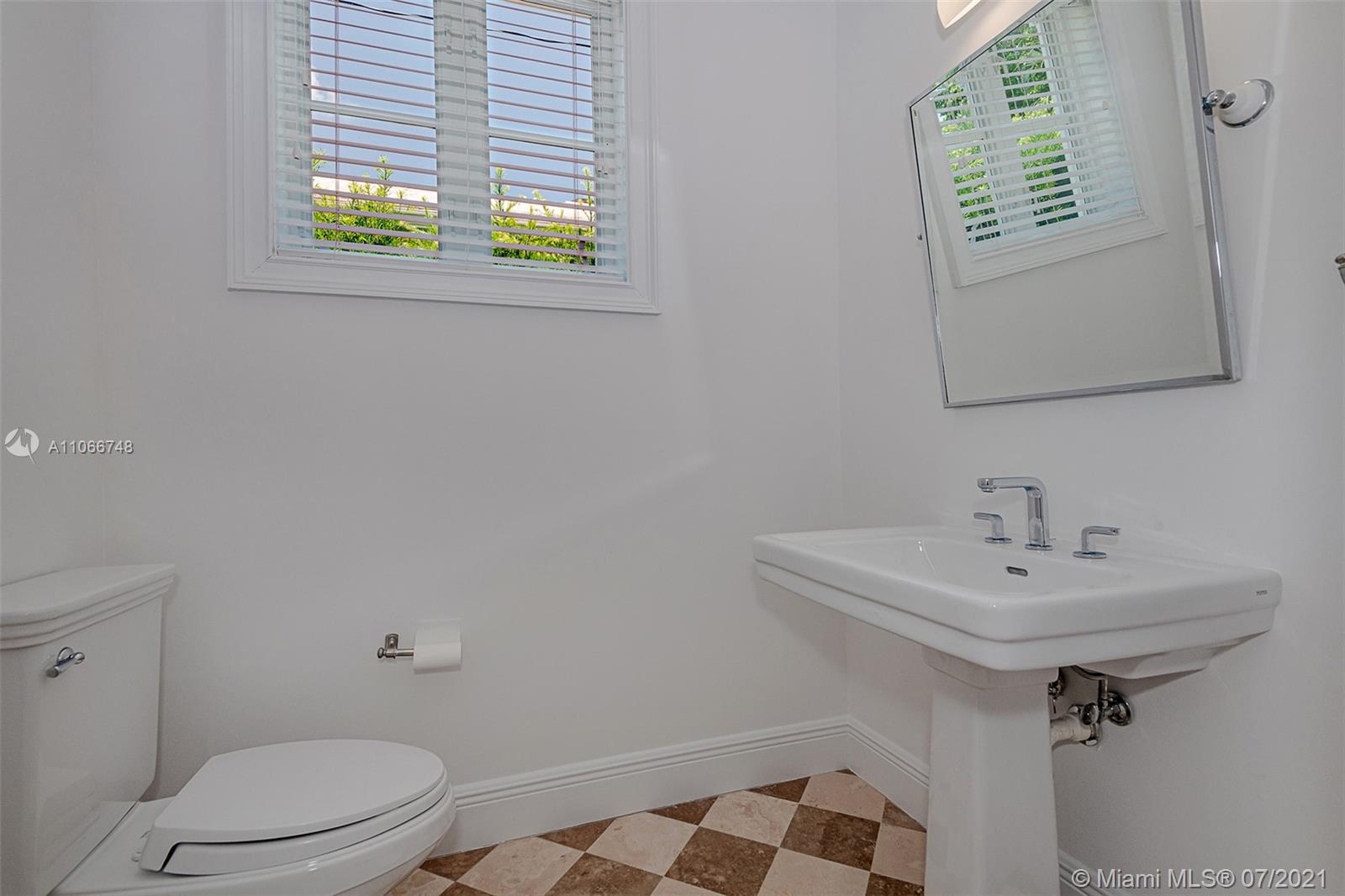 442 Woodcrest Road Key Biscayne, FL 33149 - Photo 26 of 48 a bathroom with a sink a toilet and a window
