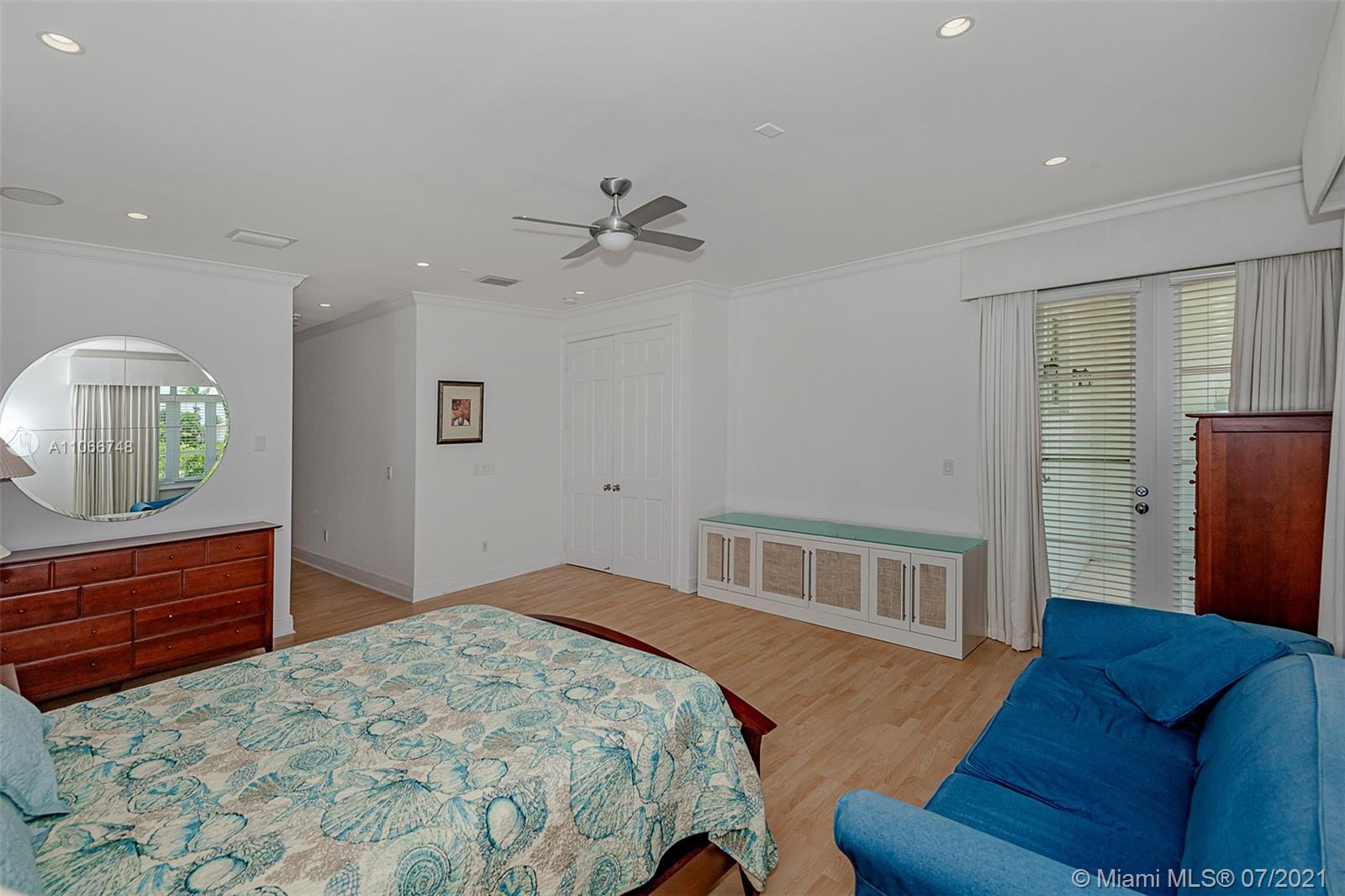 442 Woodcrest Road Key Biscayne, FL 33149 - Photo 30 of 48 a bedroom with a bed and a dresser