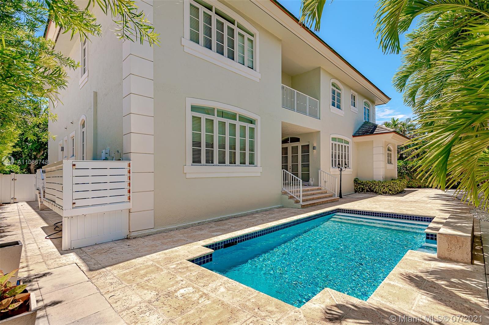 442 Woodcrest Road Key Biscayne, FL 33149 - Photo 4 of 48 a view of a house with a yard