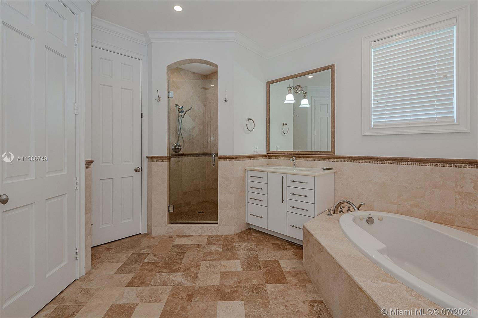 442 Woodcrest Road Key Biscayne, FL 33149 - Photo 32 of 48 a bathroom with a bathtub and a shower