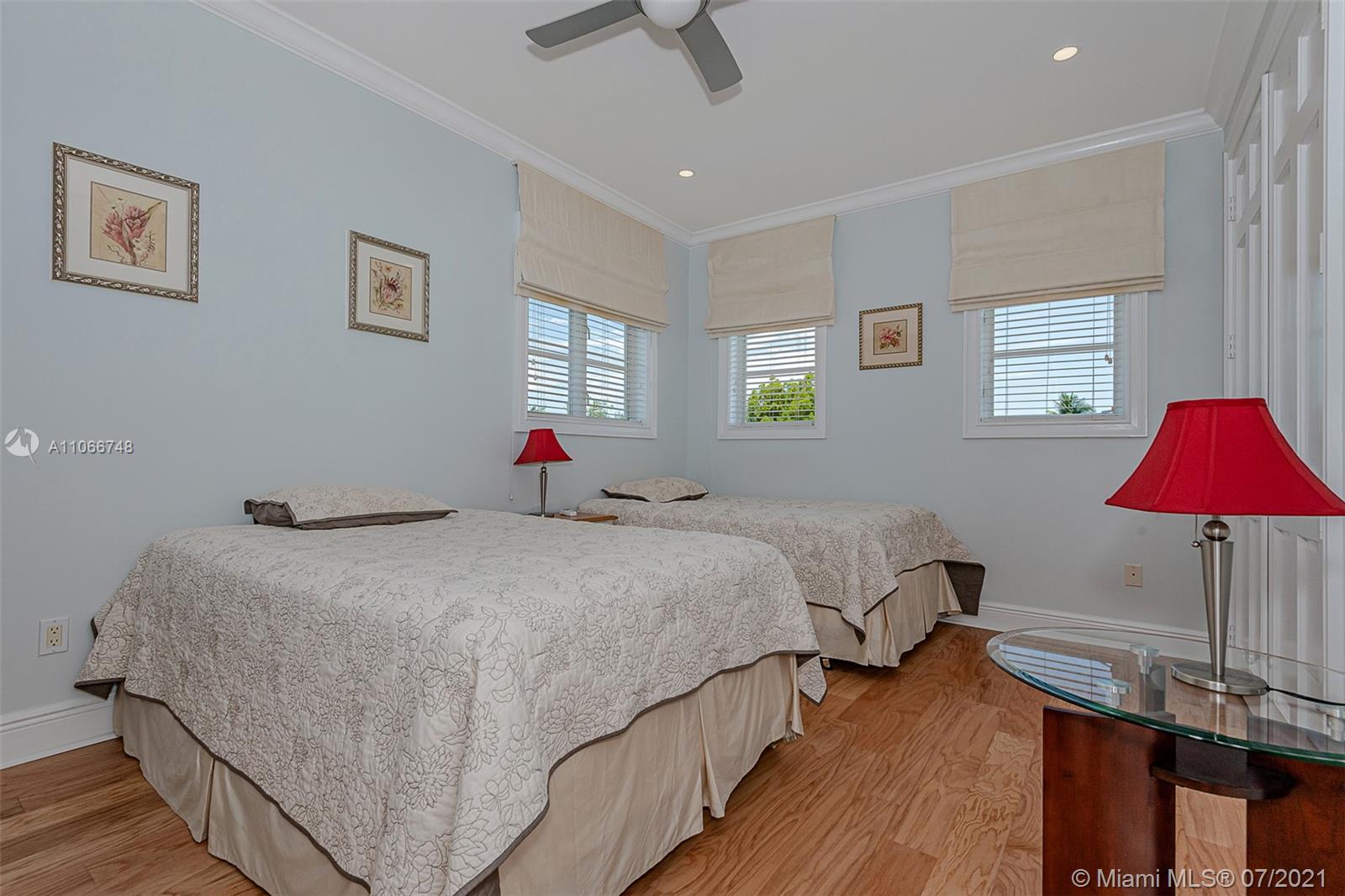 442 Woodcrest Road Key Biscayne, FL 33149 - Photo 33 of 48 a bed room with a bed and a lamp