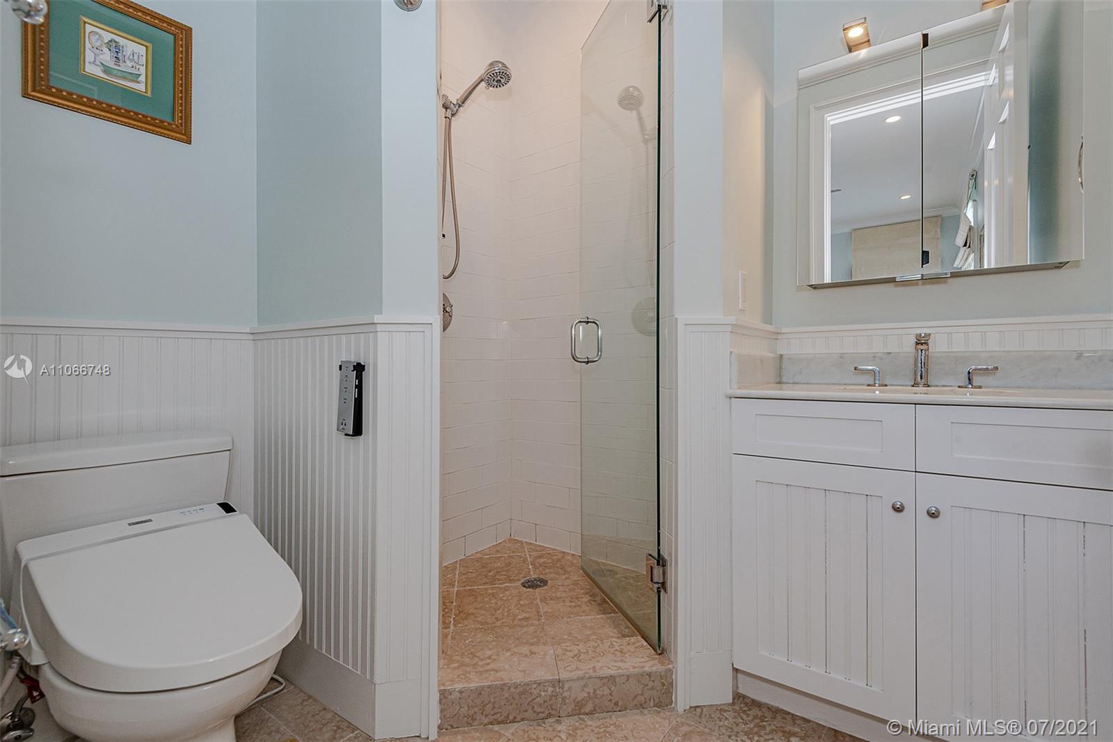 442 Woodcrest Road Key Biscayne, FL 33149 - Photo 35 of 48 a bathroom with a sink toilet and shower