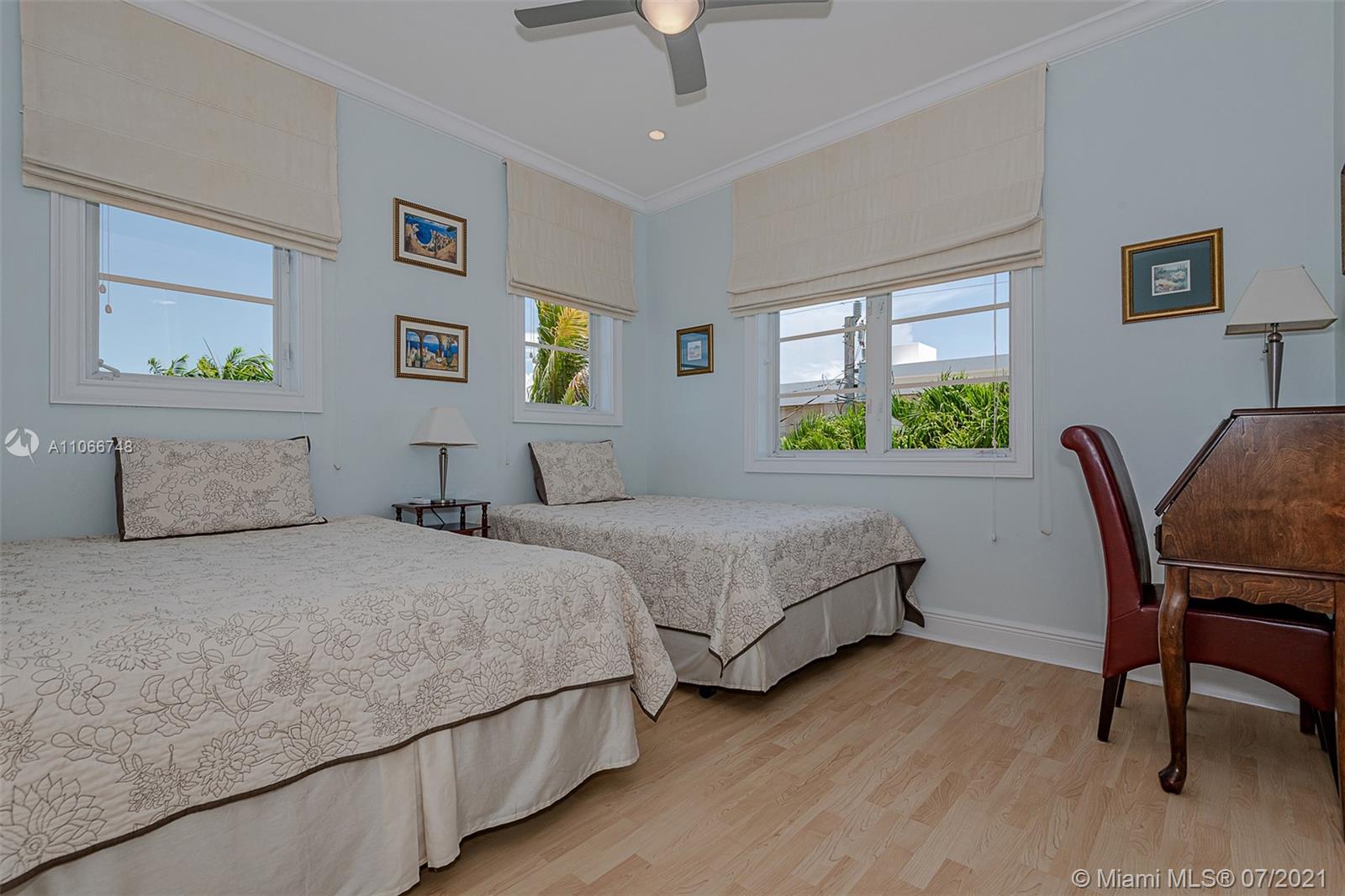 442 Woodcrest Road Key Biscayne, FL 33149 - Photo 36 of 48 a bedroom with two beds and a chair