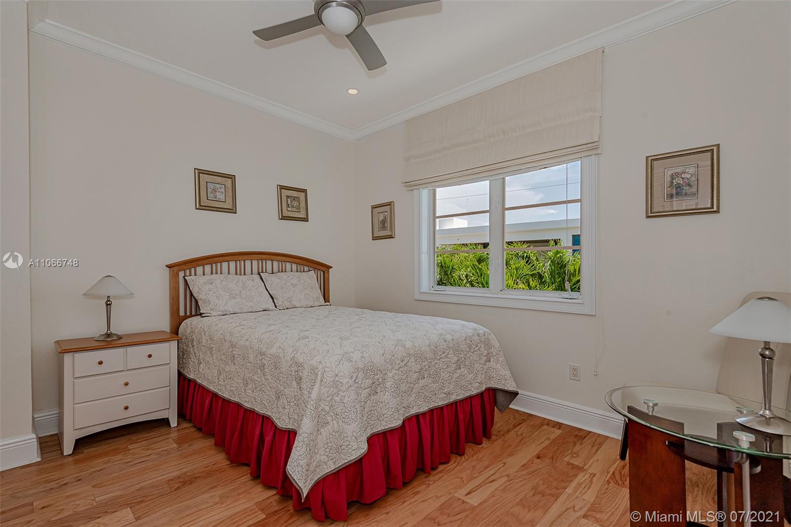 442 Woodcrest Road Key Biscayne, FL 33149 - Photo 39 of 48 a bedroom with a bed and a window