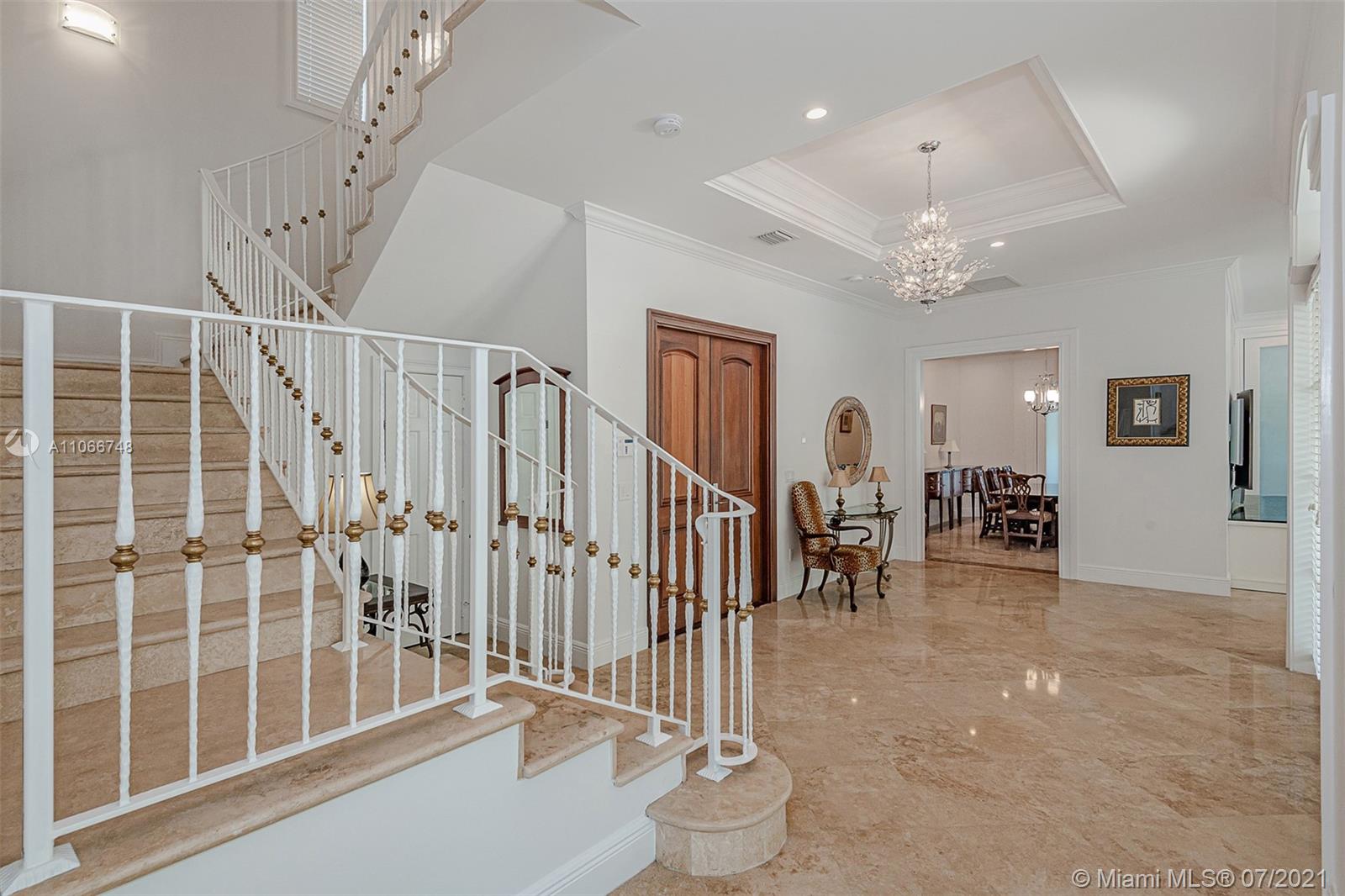 442 Woodcrest Road Key Biscayne, FL 33149 - Photo 8 of 48 a view of a hall with stairs and a floor to ceiling window